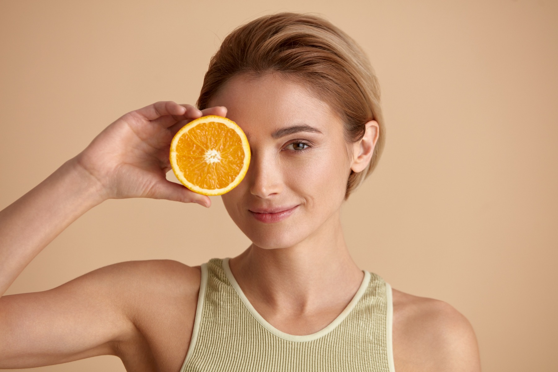 Woman holding an orange for vitamin c